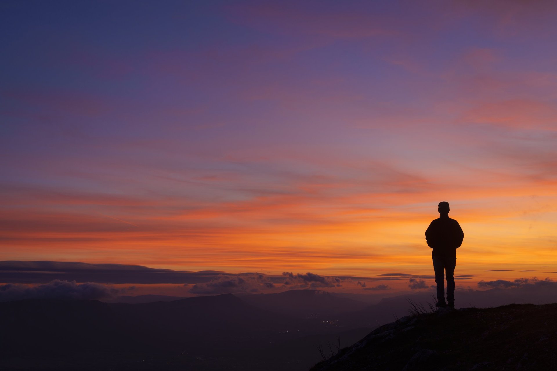 Man at sunrise looking at landscape